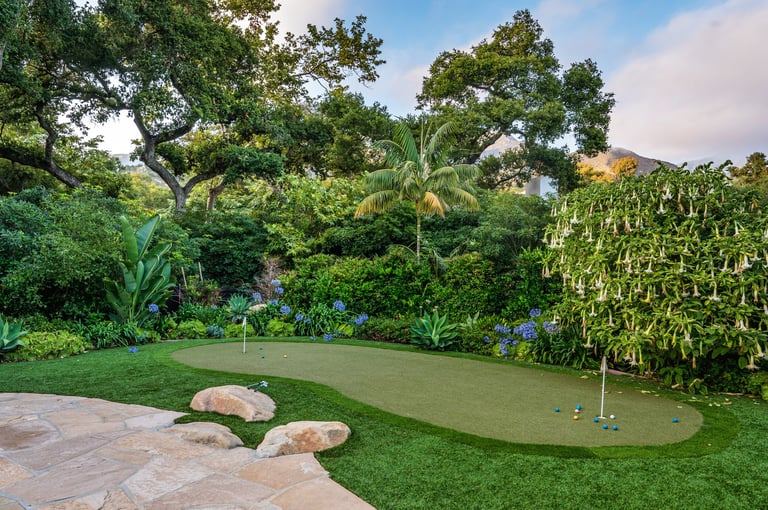Backyard putting green surrounded by trees